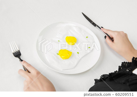 We are what we eat. Woman's eating plastic food, eco concept 60209551