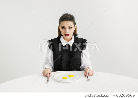 We are what we eat. Woman's eating plastic food, eco concept 60209569