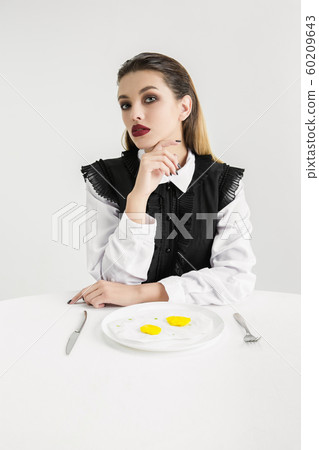 We are what we eat. Woman's eating plastic food, eco concept 60209643