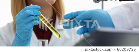 Technician hold in arms in protective gloves Technician hold in arms in protective gloves 60209759