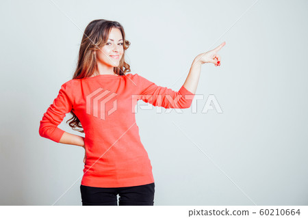 beautiful girl shows symbols of fingers and the direction 60210664