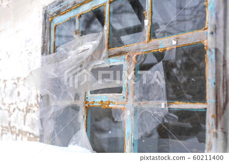 The old window is covered with cellophane film and 60211400