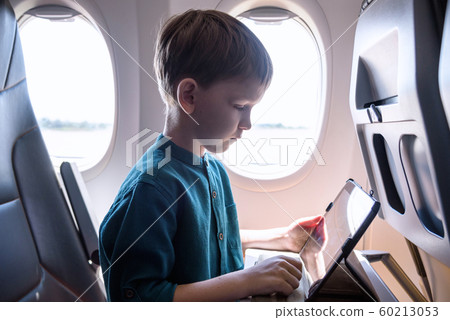 Cute six years old boy, playing on tablen in 60213053