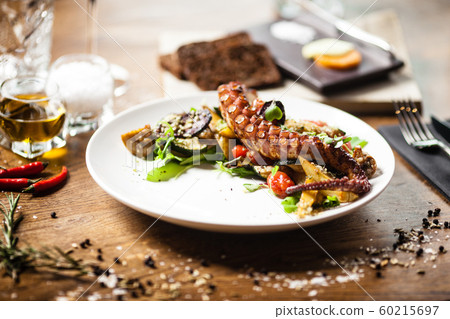 Octopus salad served on a plate in restaurant Octopus salad served on a plate in restaurant 60215697