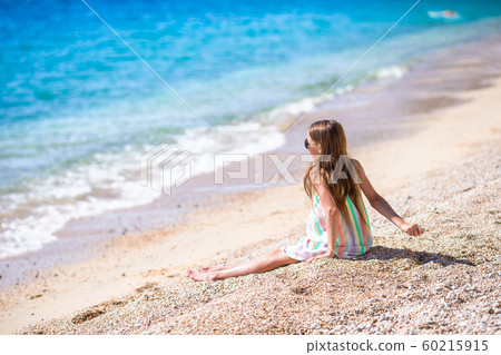 Cute little girl at beach during summer vacation Cute little girl at beach during summer vacation 60215915
