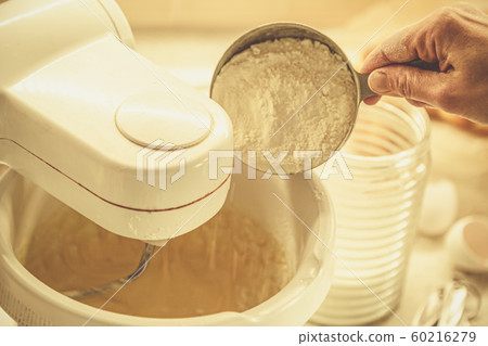 Baking concept - batter in mixer and ingredients 60216279