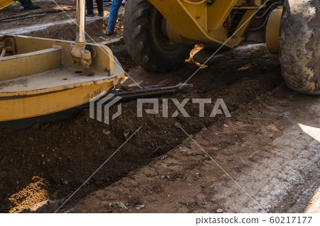 Details of grader is working on road construction. Grader industrial machine on construction of new roads. Heavy duty machinery working on highway. Construction equipment. Compaction of the road. Details of grader is working on road construction. Grader industrial machine on construction of new roads. Heavy duty machinery working on highway. Construction equipment. Compaction of the road. 60217177