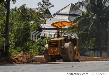 Road rollers working on the new roads construction site. Heavy duty machinery working on highway. Construction equipment. Compaction of the road. Road rollers working on the new roads construction site. Heavy duty machinery working on highway. Construction equipment. Compaction of the road. 60217286