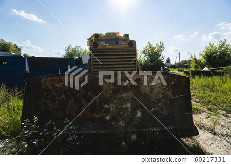 Old yellow rusty tractor in field in sunny day. Old yellow rusty tractor in field in sunny day. 60217331