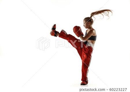 Young female kickboxing fighter training isolated on white background 60223227