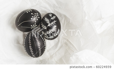 Pysanky on the white crumpled paper background 60224939