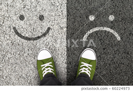 Smiles drawn on asphalt road, pros and cons 60224973