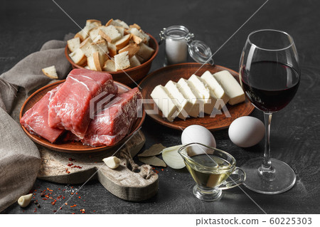 Fresh raw meat, eggs, butter on black wooden table 60225303