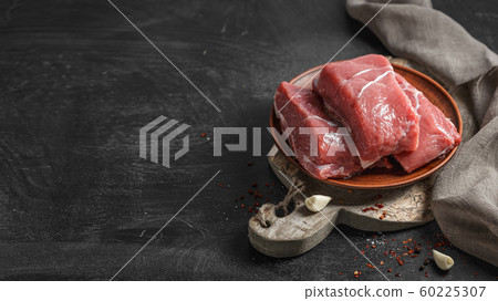 Fresh raw meat on black wooden table 60225307
