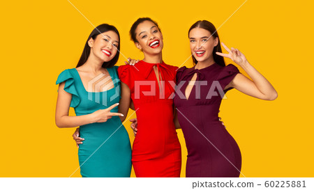 Three Diverse Girlfriends Gesturing Victory Sign Posing On Yellow Background 60225881