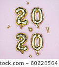 Happy New year 2020 celebration concept. Gold foil balloons numeral 2020 and golden stars on pastel 60226564