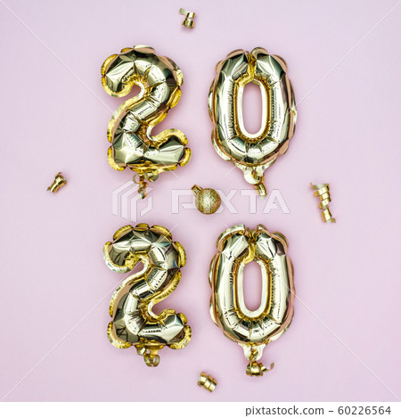 Happy New year 2020 celebration concept. Gold foil balloons numeral 2020 and golden stars on pastel Happy New year 2020 celebration concept. Gold foil balloons numeral 2020 and golden stars on pastel 60226564