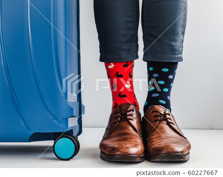 Stylish suitcase, men's legs and bright socks Stylish suitcase, men's legs and bright socks 60227667
