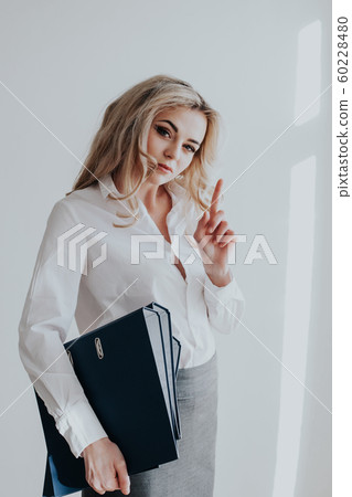 Portrait of a beautiful blonde girl in a business suit Portrait of a beautiful blonde girl in a business suit 60228480