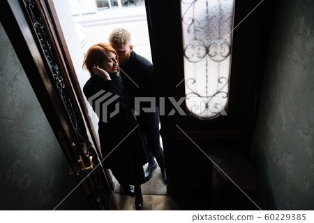 Beautiful couple posing in the doorway posing Beautiful couple posing in the doorway posing 60229385