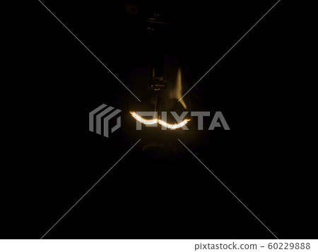 Retro incandescent bulb, light of filament floating in the dark 60229888