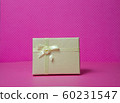 Photo of a gift box with a bow under points of view on a pink background front view 60231547