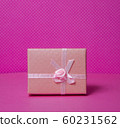 Photo of a gift box with a bow under points of view on a pink background front view 60231562