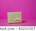 Photo of a gift box with a bow under points of view on a pink background front view 60231567