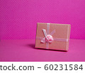 Photo of a gift box with a bow under points of view on a pink background front view 60231584