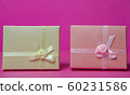 Photo of a gift box with a bow under points of view on a pink background front view 60231586
