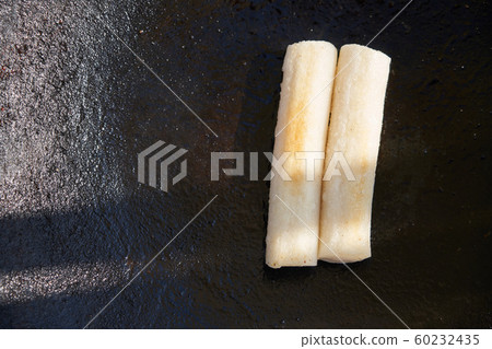 Rice cake baking on cast iron plate Rice cake baking on cast iron plate 60232435