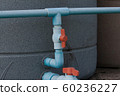 water pipe with red valve and tank 60236227