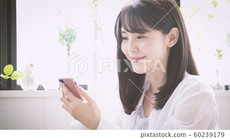 A woman operating a smartphone A woman operating a smartphone 60239179
