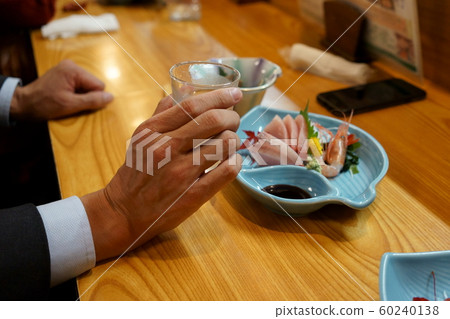 A sashimi and sake, a salaried worker drinking alone 60240138
