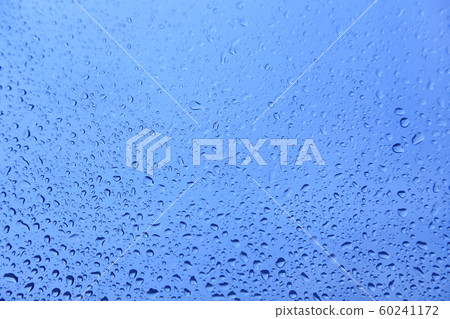 Water drops on glass, natural blue texture 60241172