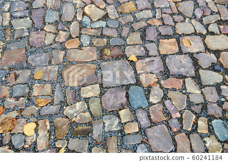 Old pavement of stones of different colors and 60241184