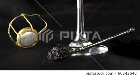 Black caviar, a glass of champagne, and a champagne cork with the number 2020, a happy New Year panorama 60242646