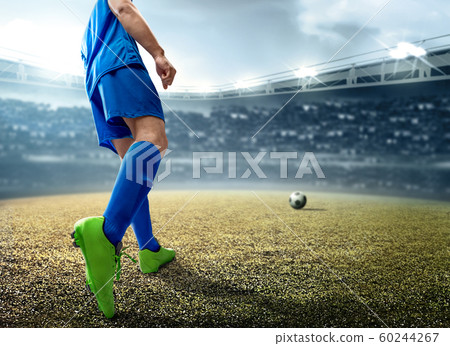 Rear view of Asian football player man kicking the ball 60244267