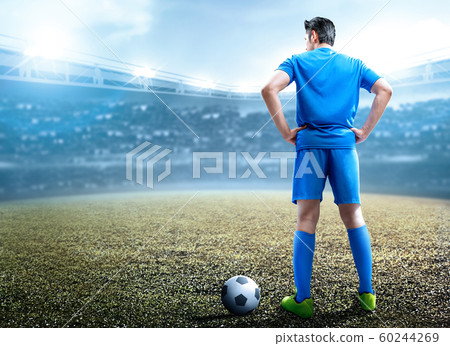 Rear view of Asian football player man standing with the ball Rear view of Asian football player man standing with the ball 60244269
