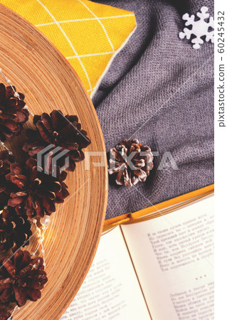 Christmas composition with cones in wooden plate. 60245432