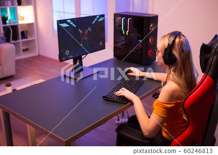 Girl relaxing playing games on computer Girl relaxing playing games on computer 60246813