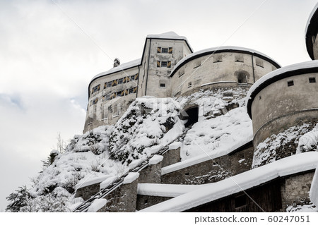 Old medieval european unassailable fortress or castle on hill at alpine austrian Kufstein city covered with big snow layer after blizzard in winter. Beautiful historical landmark 60247051