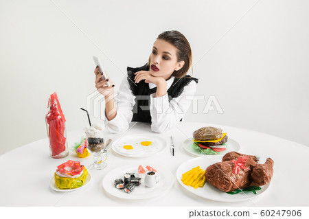 We are what we eat. Woman's eating plastic food, eco concept 60247906