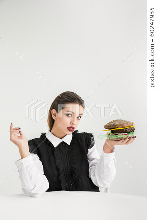 We are what we eat. Woman's eating plastic food, eco concept 60247935