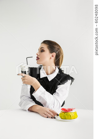 We are what we eat. Woman's eating plastic food, eco concept We are what we eat. Woman's eating plastic food, eco concept 60248098
