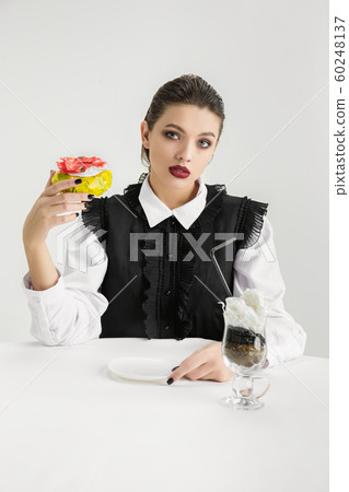 We are what we eat. Woman's eating plastic food, eco concept 60248137