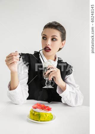We are what we eat. Woman's eating plastic food, eco concept 60248145