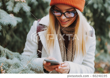 Pretty young lady using her modern smartphone Pretty young lady using her modern smartphone 60248195