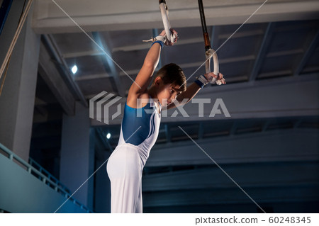 Little male gymnast training in gym, flexible and active Little male gymnast training in gym, flexible and active 60248345