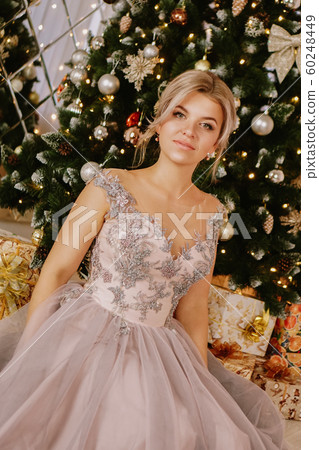 Christmas, winter holidays concept. Beautiful woman in evening long dress 60248449